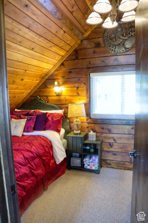 Bedroom with lofted ceiling, carpet flooring, an inviting chandelier, and wood ceiling
