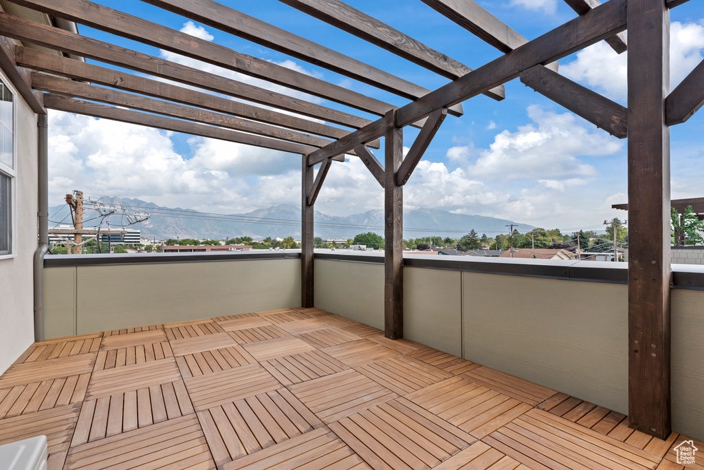 Wooden terrace featuring a mountain view and a pergola
