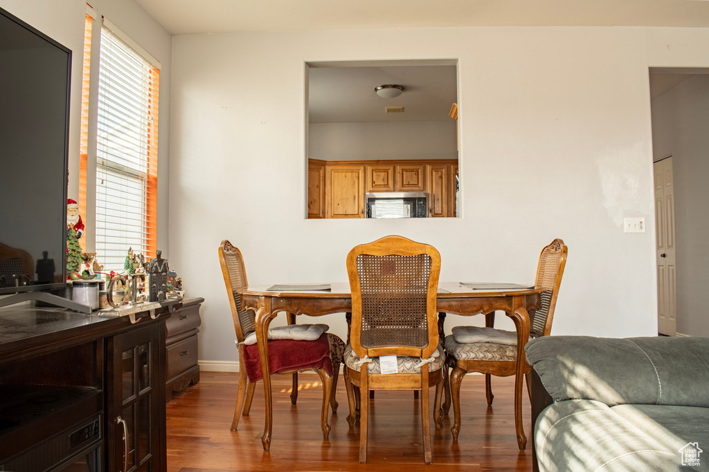 Dining room with dark hardwood / wood-style flooring