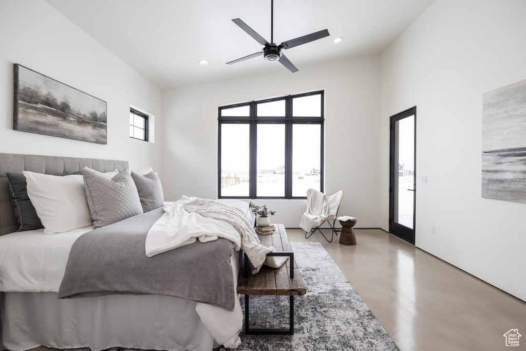 Bedroom featuring multiple windows, ceiling fan, and access to exterior