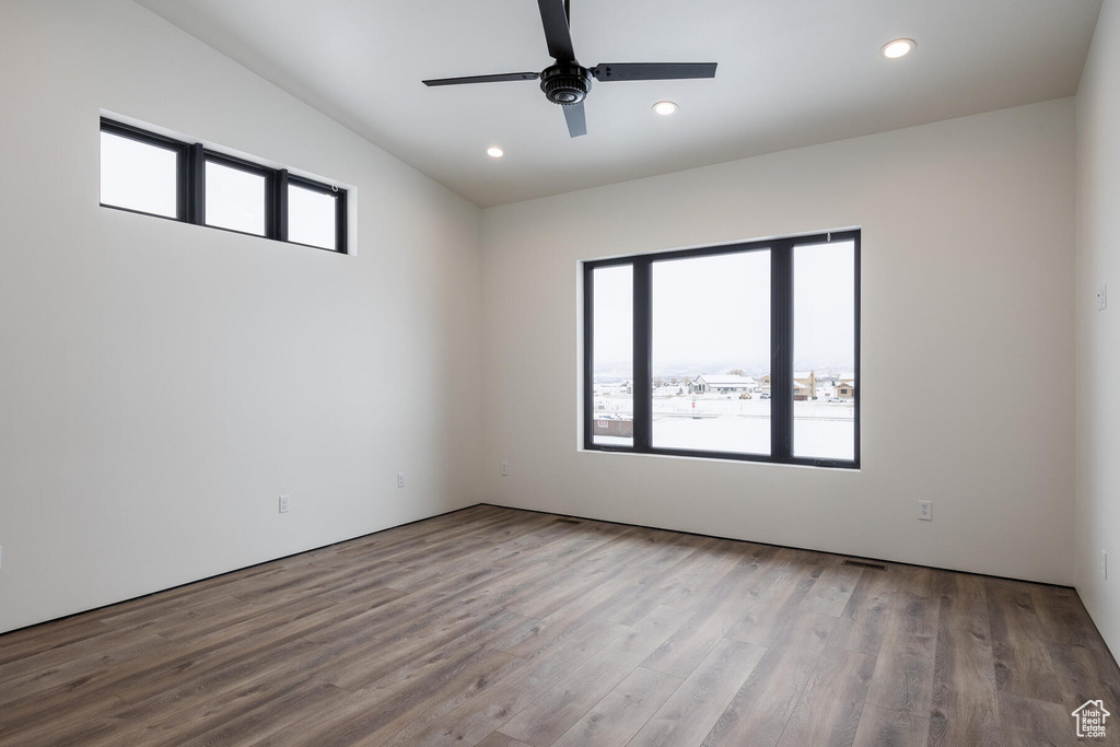 Empty room with light hardwood / wood-style flooring, plenty of natural light, and ceiling fan
