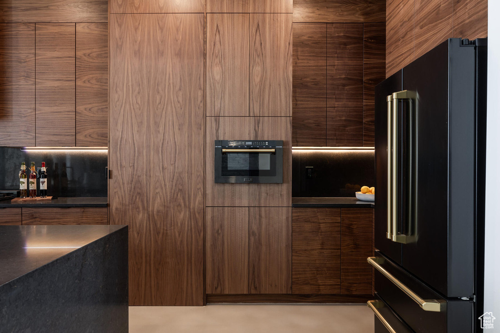 Kitchen with high end fridge and black oven