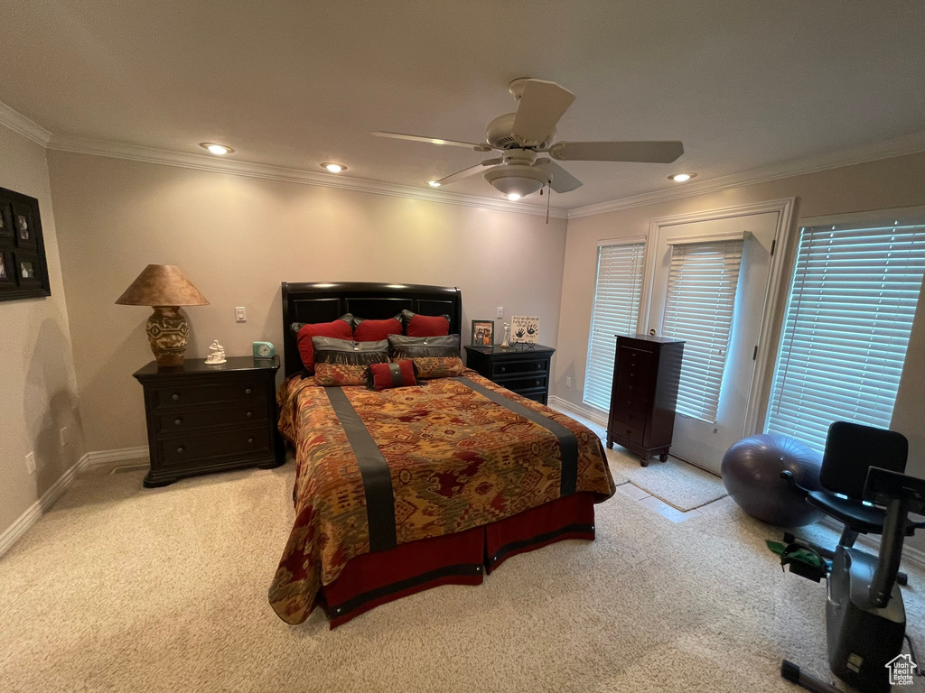 Bedroom featuring light colored carpet, ornamental molding, and ceiling fan