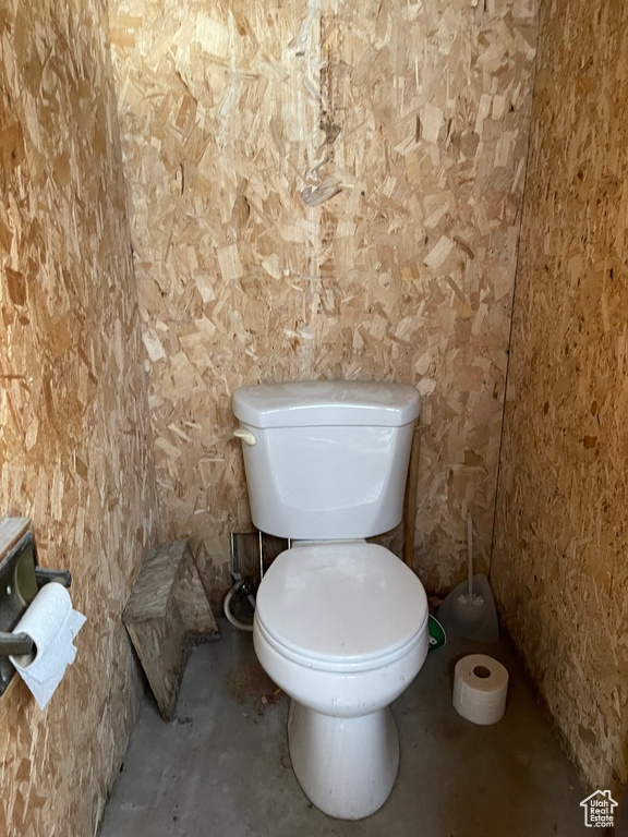 Bathroom with toilet and concrete floors
