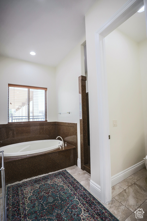 Bathroom with a bathing tub and tile floors
