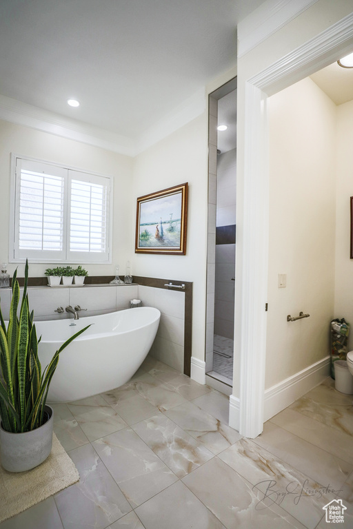 Bathroom with tile flooring and a tub