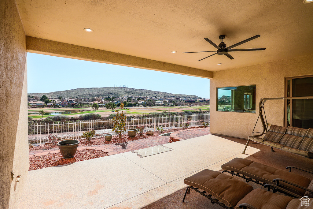 View of patio / terrace featuring a mountain view and ceiling fan