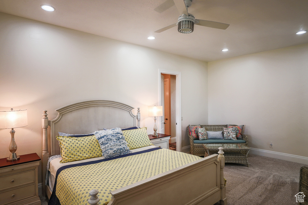 Bedroom with dark colored carpet and ceiling fan