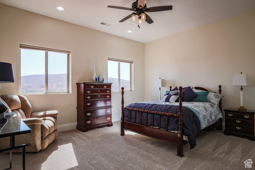 Bedroom featuring a mountain view, carpet, and ceiling fan