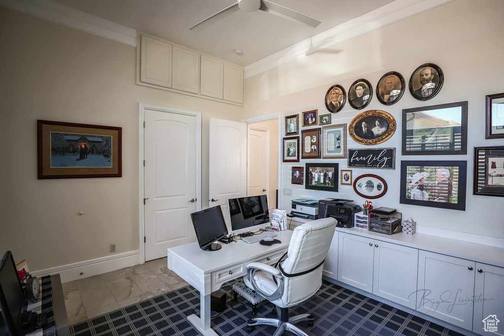 Tiled office space with ornamental molding and ceiling fan