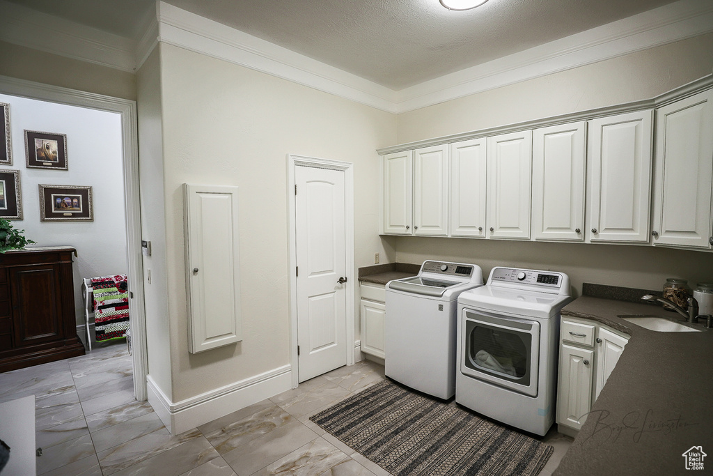 Washroom featuring sink, cabinets, independent washer and dryer, and light tile floors