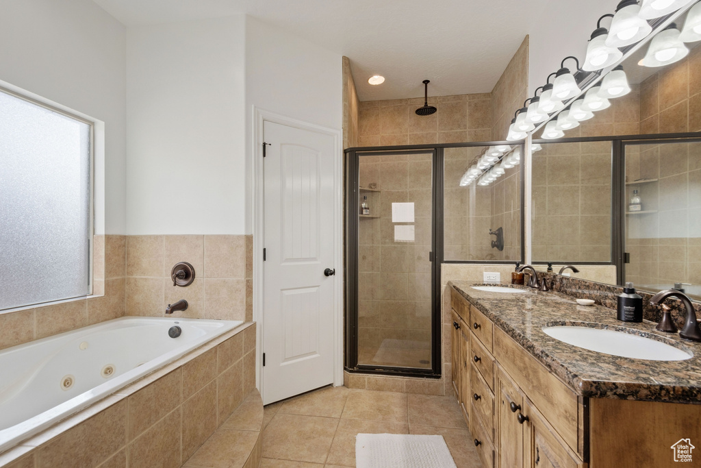 Bathroom featuring dual bowl vanity, tile flooring, and plus walk in shower