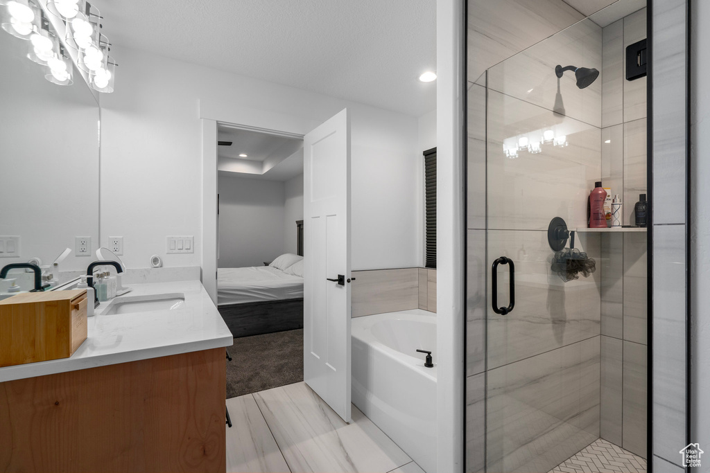 Bathroom with dual vanity, tile floors, and plus walk in shower