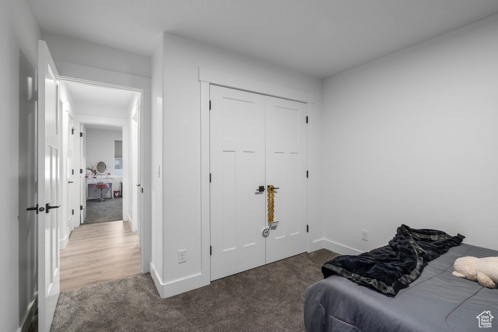 Bedroom featuring dark hardwood / wood-style flooring and a closet