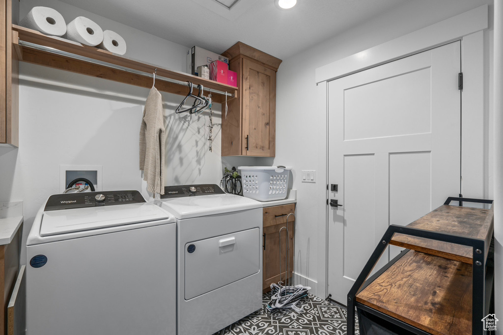 Laundry room with tile flooring, cabinets, washer hookup, and separate washer and dryer