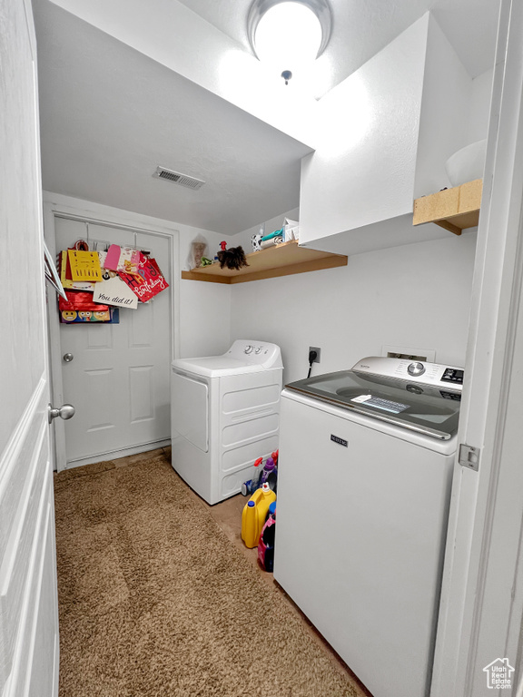 Laundry area featuring independent washer and dryer, light colored carpet, and hookup for an electric dryer
