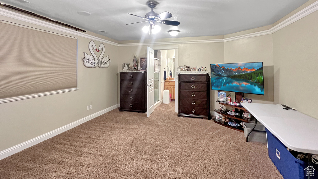 Office area with light carpet, ceiling fan, and crown molding