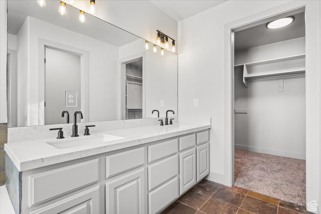 Bathroom with dual vanity and tile flooring