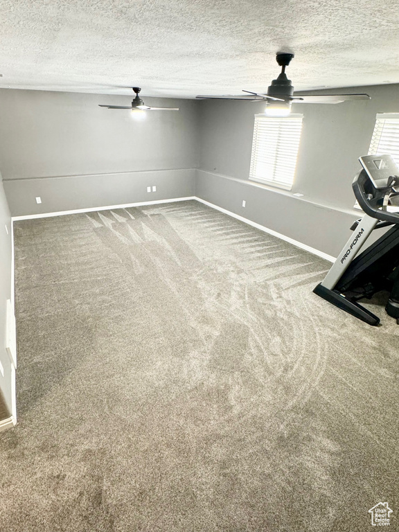 Spare room with carpet, a textured ceiling, and ceiling fan