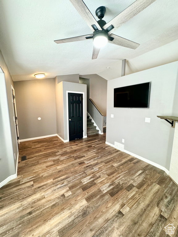 Spare room with dark hardwood / wood-style floors, a textured ceiling, and ceiling fan
