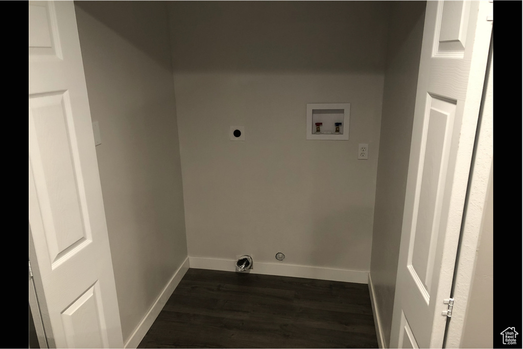 Clothes washing area with washer hookup, dark hardwood / wood-style flooring, and hookup for an electric dryer