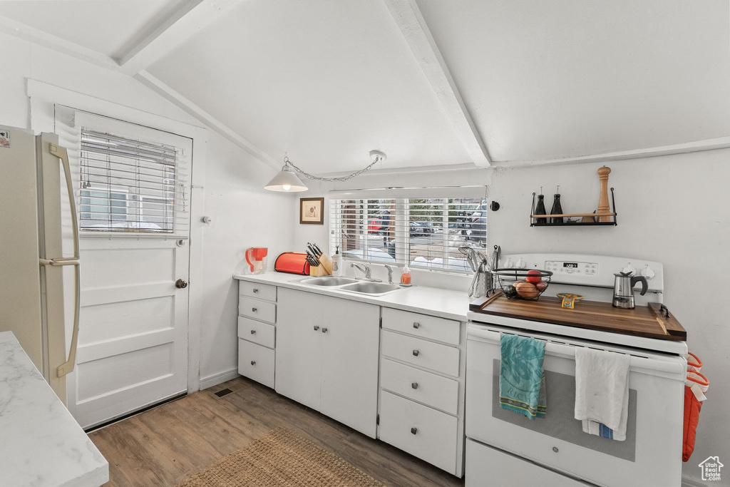 Kitchen with lofted ceiling, light wood-type flooring, white cabinets, sink, and white appliances