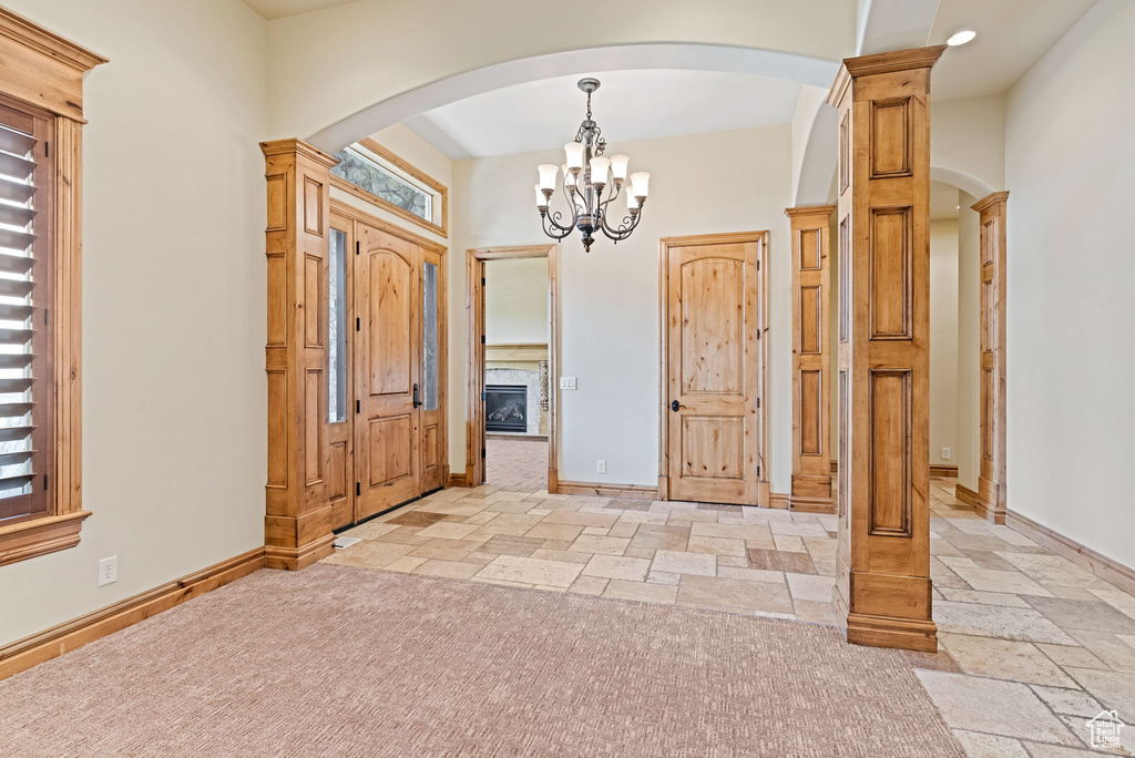 Entrance foyer with an inviting chandelier and light tile floors