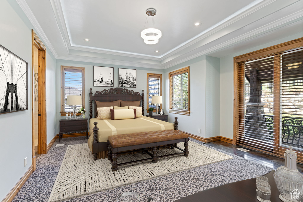 Bedroom featuring ornamental molding and a tray ceiling