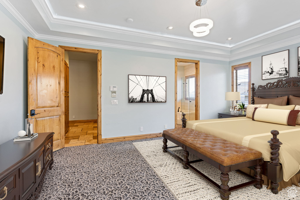Tiled bedroom with ornamental molding and a tray ceiling