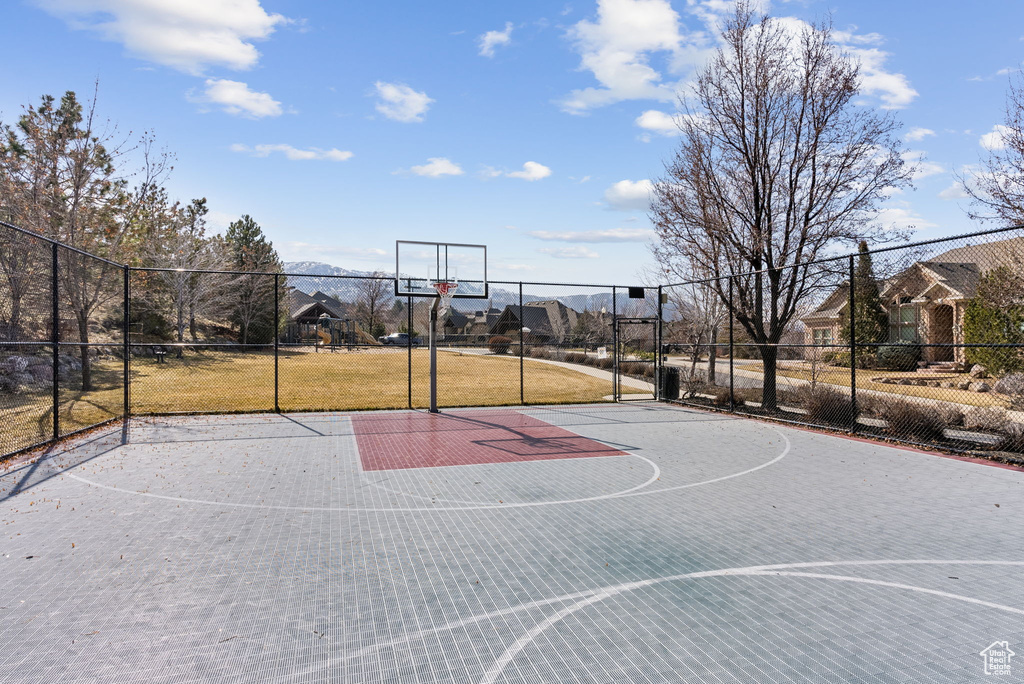 View of basketball court with a yard