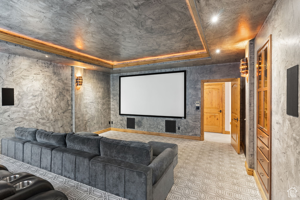 Tiled home theater featuring a tray ceiling