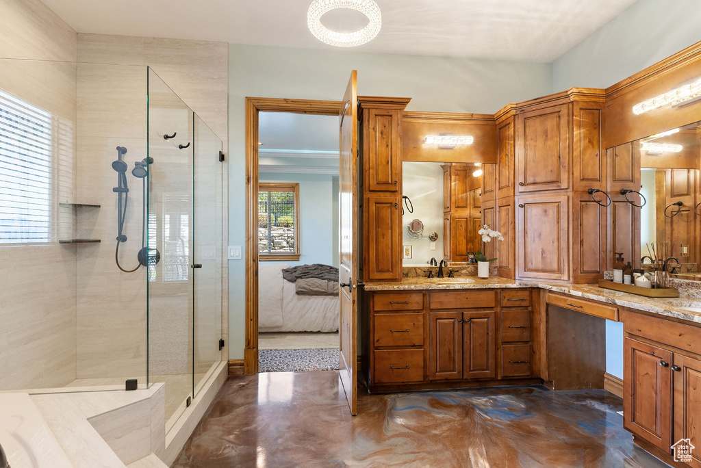 Bathroom featuring vanity and a shower with shower door