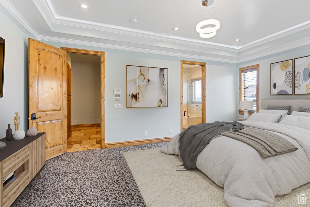 Bedroom featuring ornamental molding and ensuite bath