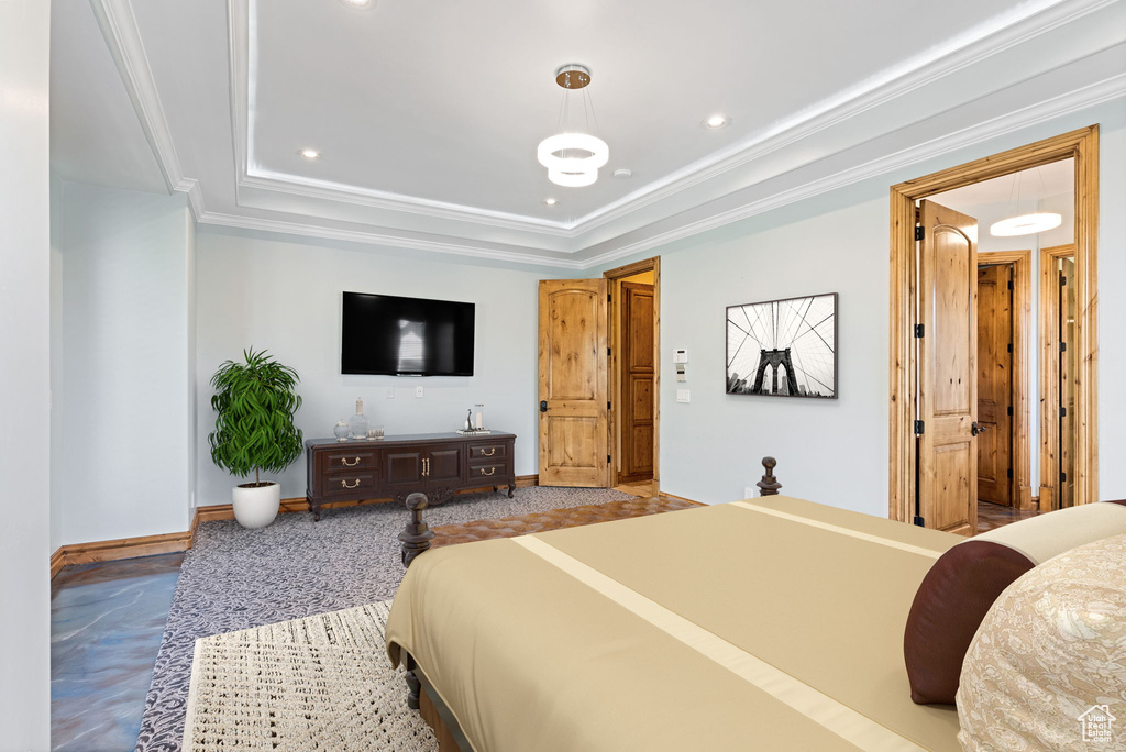 Bedroom featuring crown molding and a raised ceiling