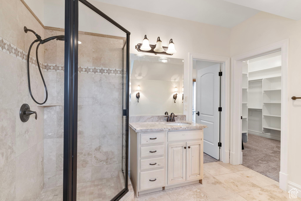 Bathroom with vanity and a shower with shower door