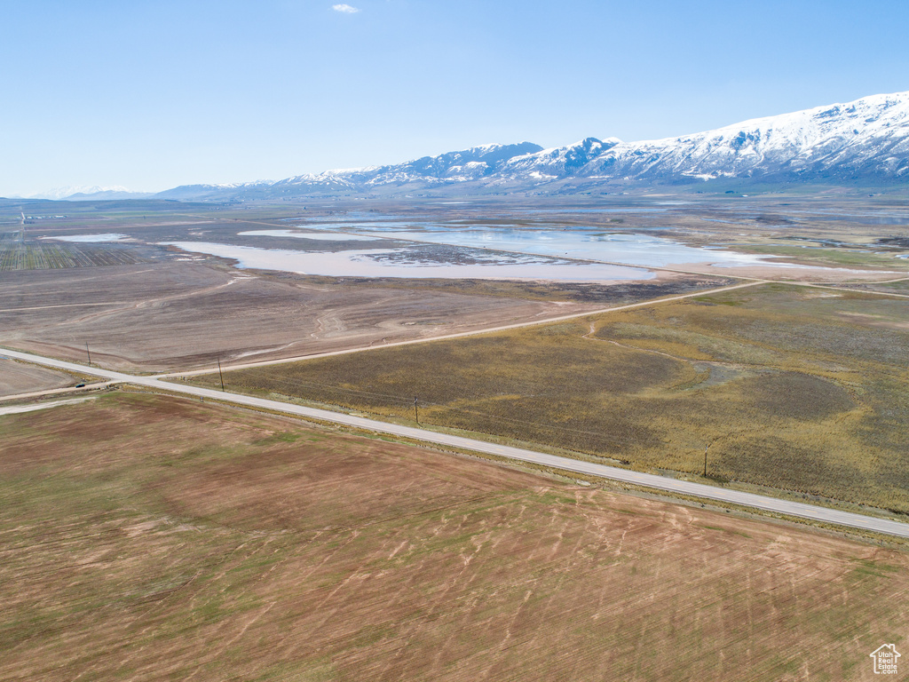 Birds eye view of property with a water and mountain view and a rural view