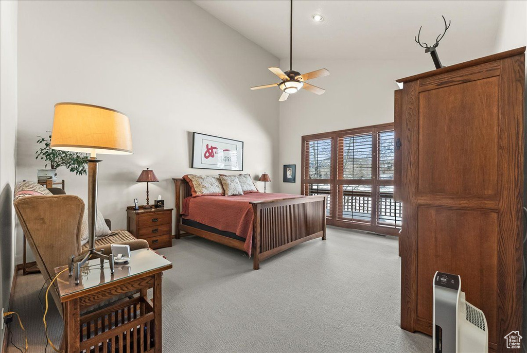 Bedroom featuring light colored carpet, high vaulted ceiling, access to outside, and ceiling fan