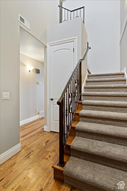 Stairway featuring hardwood / wood-style floors