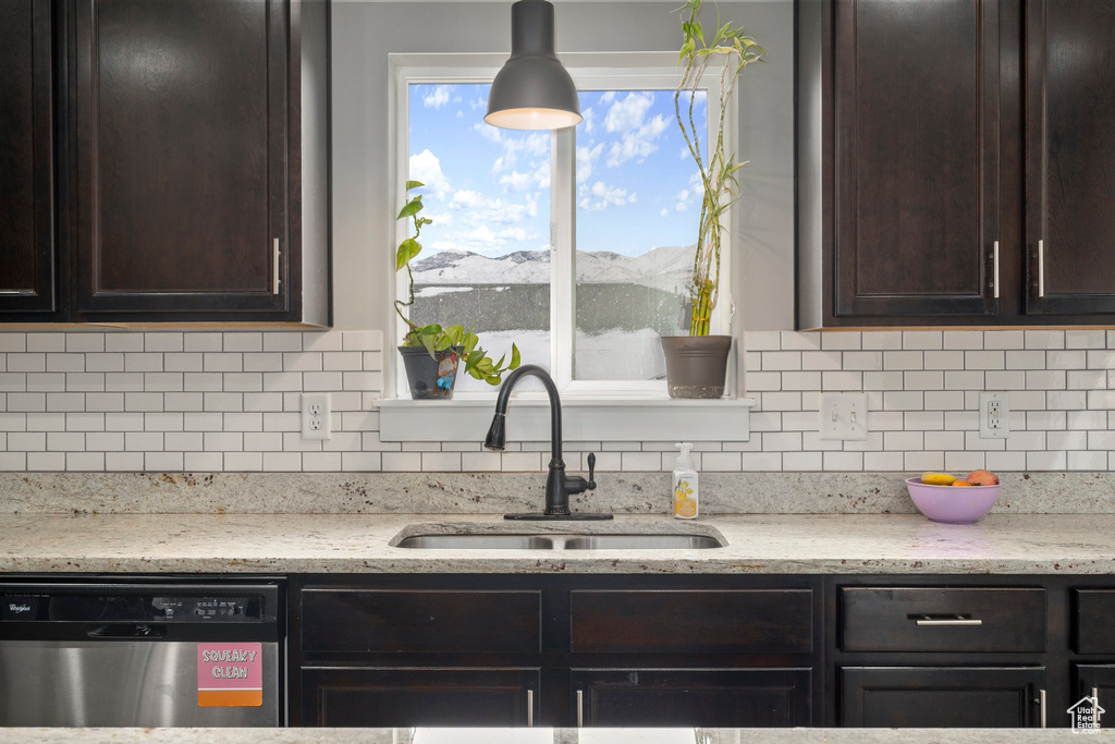Kitchen featuring sink, a mountain view, dark brown cabinets, and stainless steel dishwasher