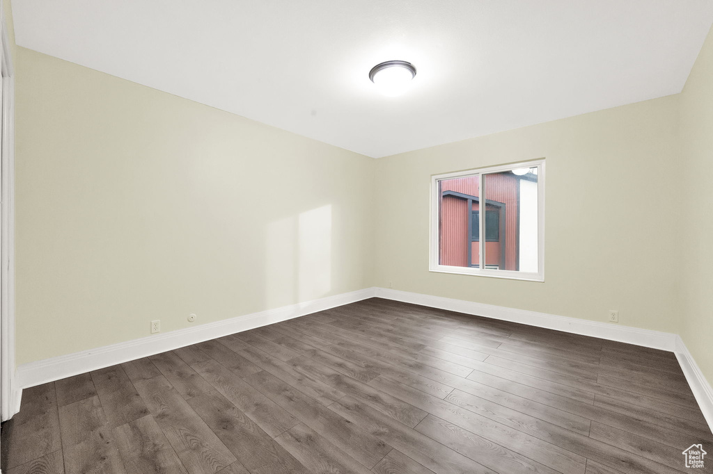 Unfurnished room featuring dark wood-type flooring