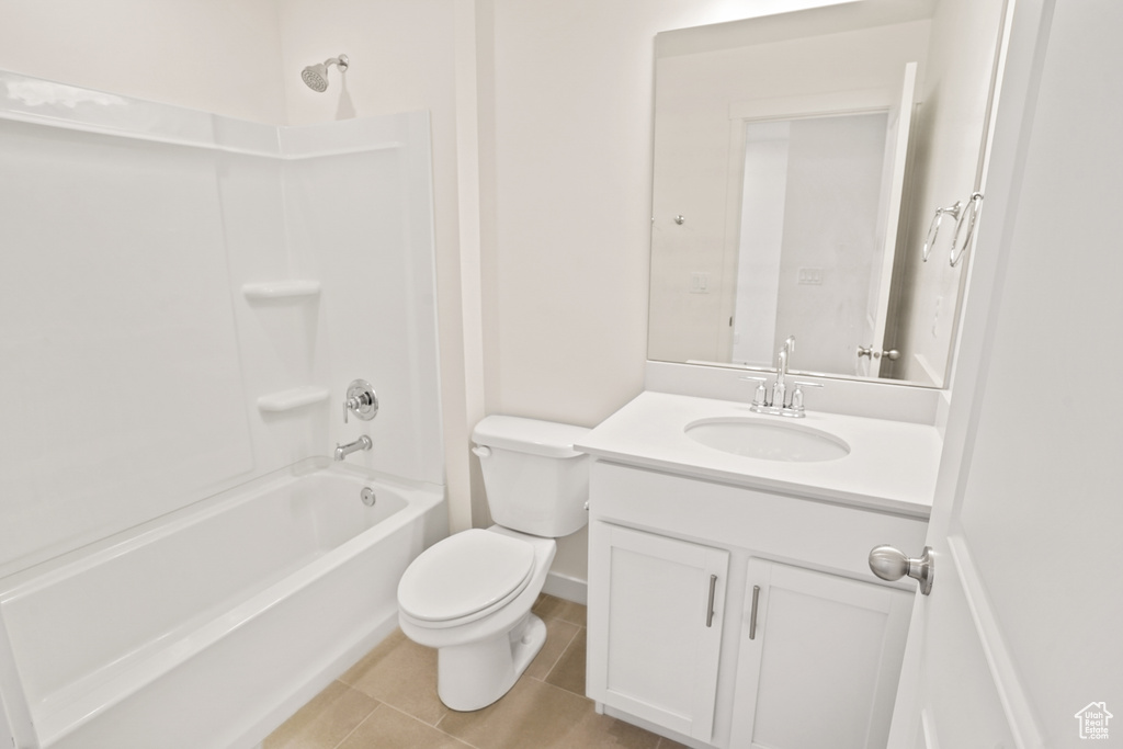 Full bathroom with  shower combination, tile floors, toilet, and vanity