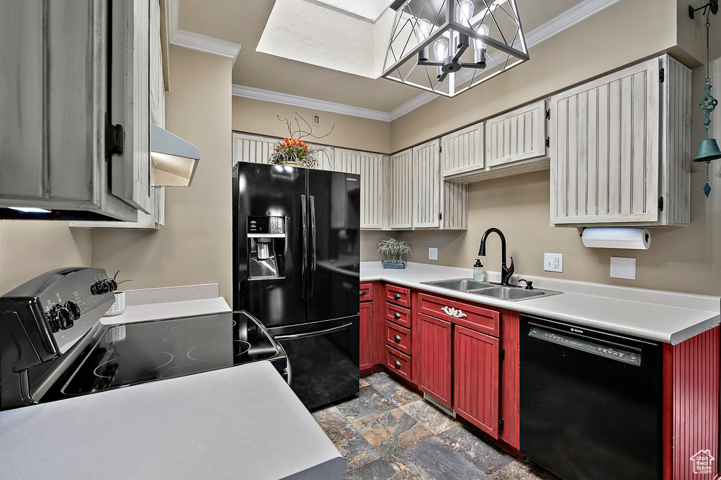 Kitchen featuring dark tile floors, sink, wall chimney exhaust hood, black appliances, and an inviting chandelier