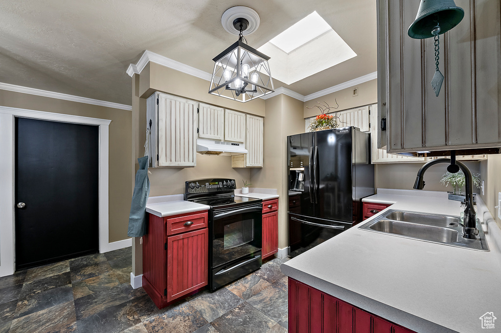 Kitchen with black appliances, sink, a notable chandelier, dark tile flooring, and a skylight