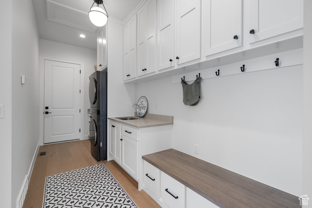 Mudroom with sink and light hardwood / wood-style flooring