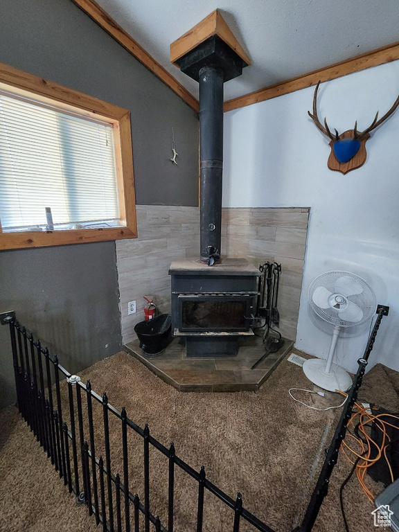 Interior space featuring a wood stove and lofted ceiling