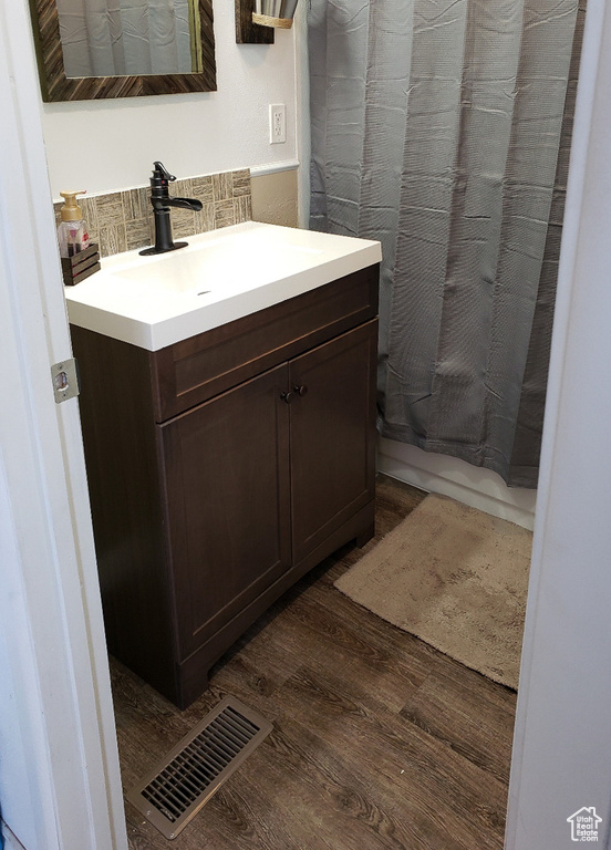 Bathroom featuring vanity and hardwood / wood-style floors