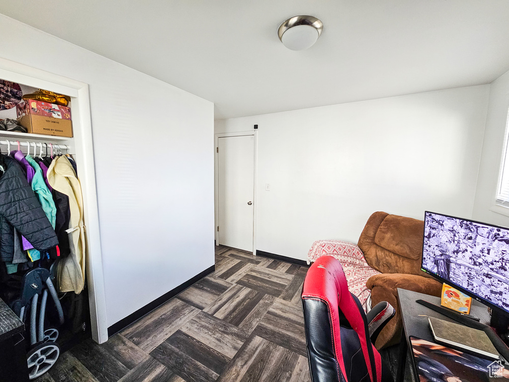 Interior space with a closet and dark parquet flooring