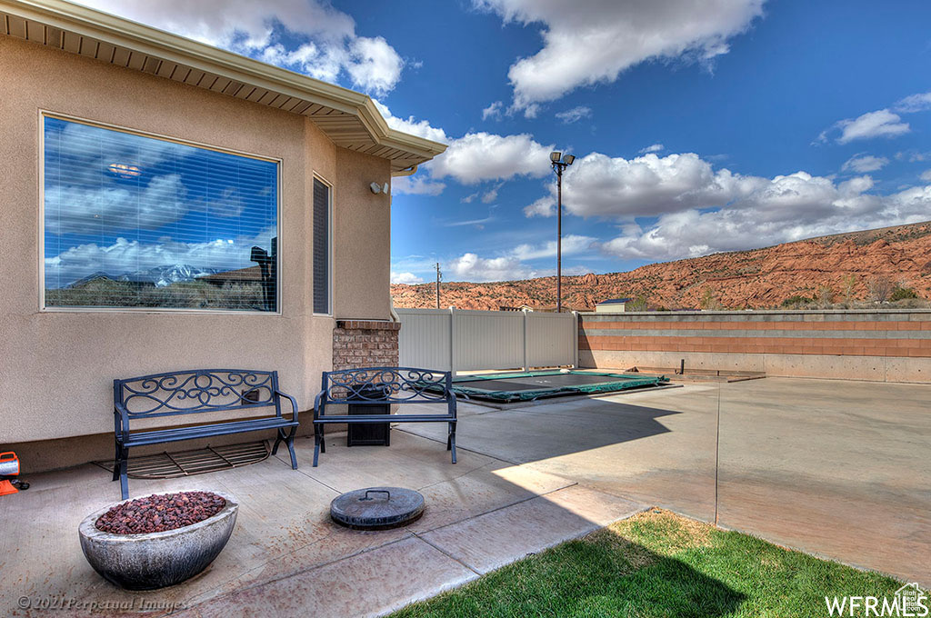 View of terrace featuring a fire pit and a mountain view