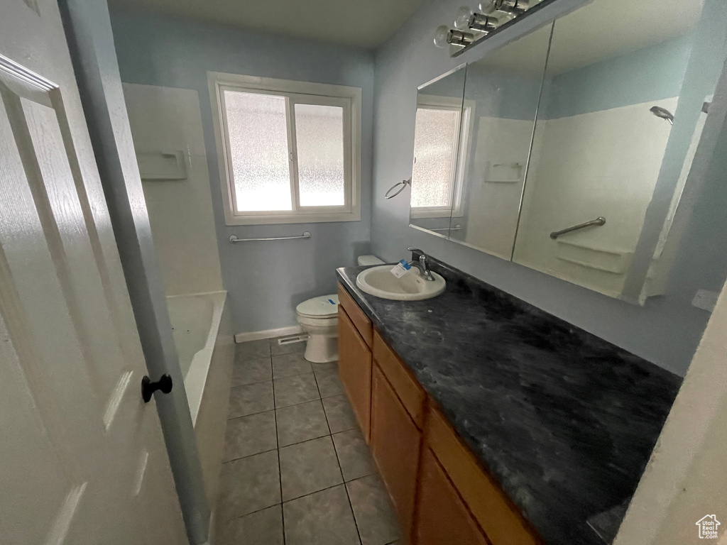 Bathroom with tile floors, toilet, and oversized vanity