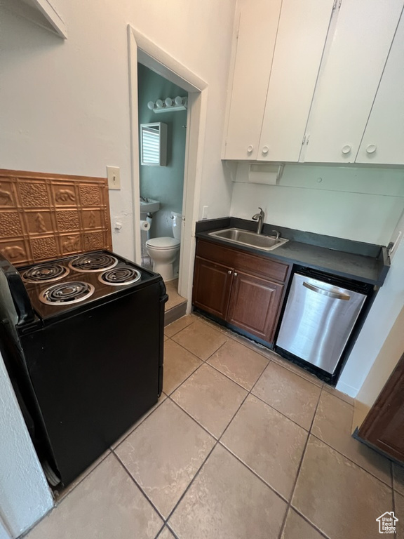 Kitchen featuring light tile floors, dishwasher, white cabinetry, sink, and electric range